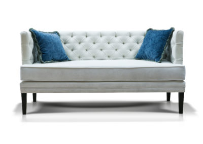 white sofa with two blue pillows  isolated on white background